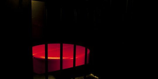 Sexy circular bed in the dark room.